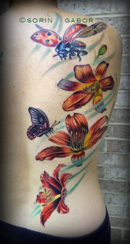 Sorin Gabor - Realistic lilies, lady bug, and butterly half back feminine tattoo